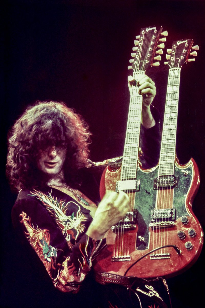 Jimmy Page performs onstage during a Led Zeppelin concert at Earl's Court, London, 1975. © Alamy.