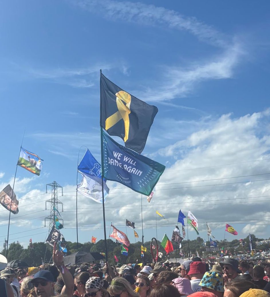 🎗️Hostage ribbon and Nova memorial ‘we will dance again’ flag flying proudly at Glastonbury Music Festival 2025.