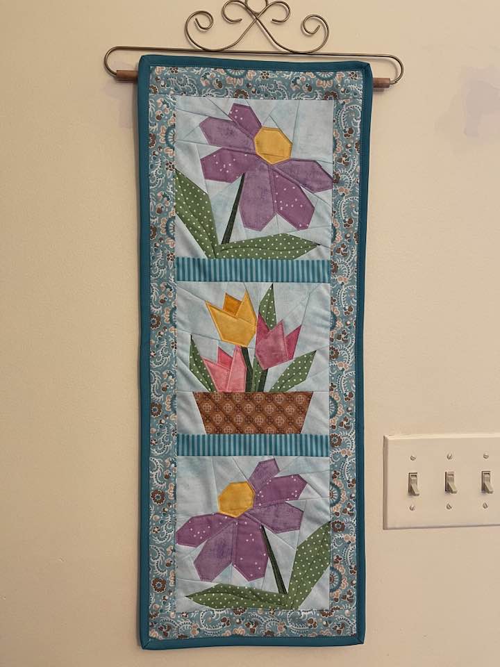thimblesquilts's tweet photo. Pat Kroesch made a gorgeous wall hanging of paper-pieced flowers! 

#ThimblesQuilts #ThimblefulofsewistsandQuilters #FinishFriday https://t.co/Z3uMGlSEPZ