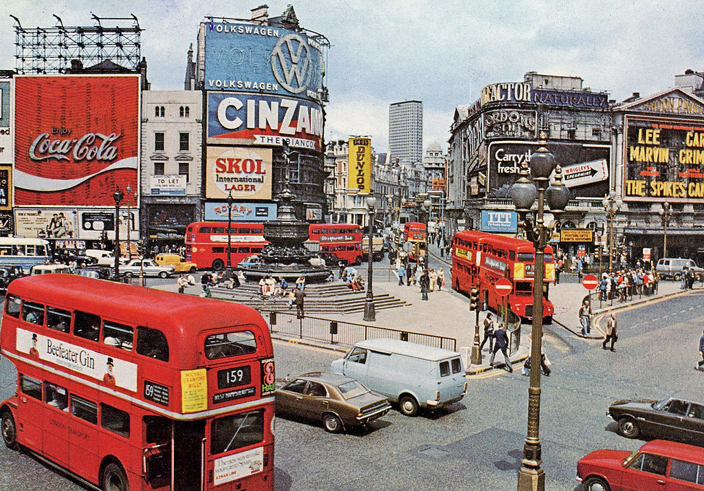 A vibrant scene of Piccadilly Circus, maybe 1960s or 1970s ?