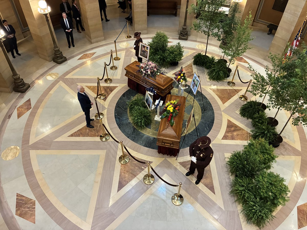 Allie_Kite's tweet image. President Joe Biden pays his respects to Minnesota House DFL Leader Melissa Hortman as she lies in state at the Capitol alongside her husband, Mark, and dog, Gilbert.