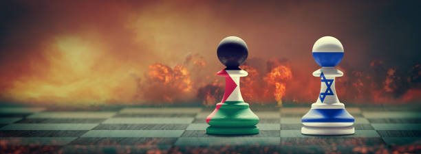The image depicts two chess pawns on a chessboard, one representing Israel with the Israeli flag colors and the other representing Palestine with the Palestinian flag colors. The background is a dramatic scene with a fiery, war-like atmosphere, symbolizing conflict. This visual metaphor aligns with the post text discussing potential ceasefire negotiations in Gaza, the influence of Iran's defeat on Hamas's negotiation stance, and the broader goal of a comprehensive agreement including peace, hostage return, and expansion of the Abraham Accords.