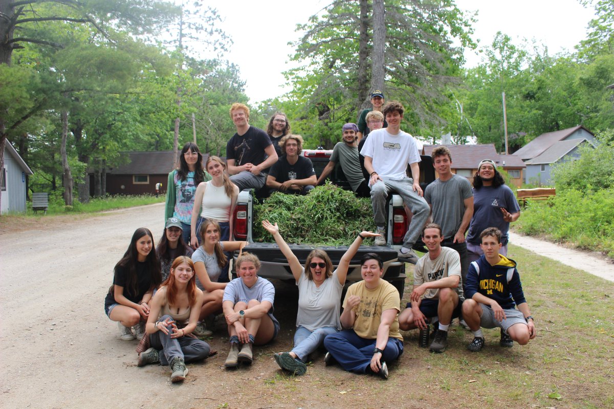 UMBS's tweet image. As a community service project, @UMBS students in the General Ecology Lab course taught by Dr. Corrine Monks, pictured in the bottom middle of the group photo, weeded the rain garden outside Gates Lecture Hall.