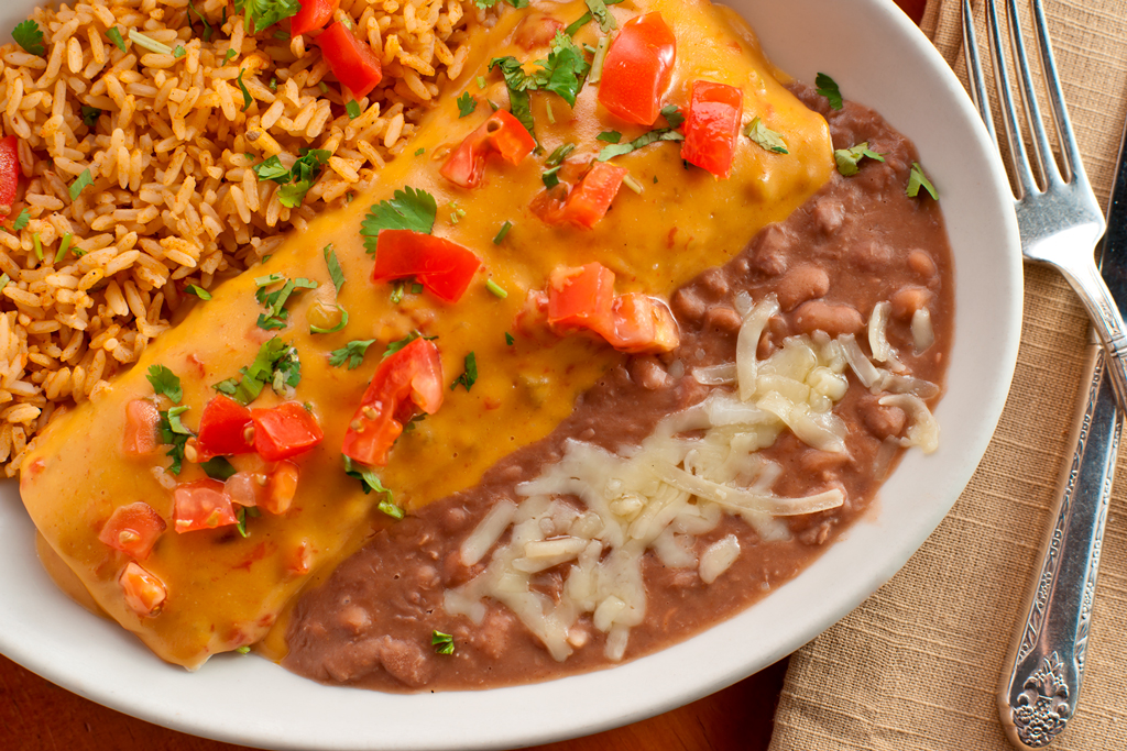 Sink your teeth into our Burrito con Queso — a warm, soft flour tortilla packed with spicy seasoned beef, then smothered in rich, velvety chili con queso.