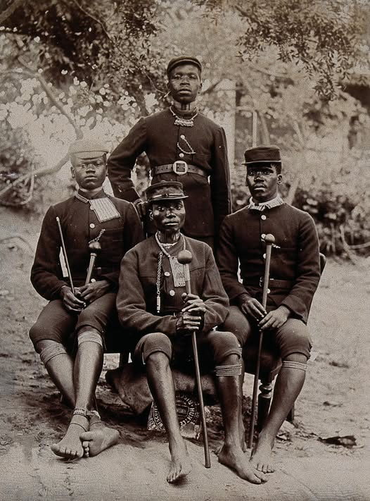 thyphoidjack's tweet photo. African Policemen in Natal, 1896📷
A photo from 1896 shows four African policemen in uniform in the British colony of Natal, South Africa. It provides a rare visual record of the African men who served in the colonial police during this time.
These men were likely members of the Natal Police, a force established in 1874 by Major John Dartnell. By the 1890s, the force included both white and African policemen. African constables were often used in rural areas, where their knowledge of local languages and communities was seen as useful.
Though African policemen were not given the same status or authority as white officers, they were expected to carry out a wide range of duties - patrolling, tracking, gathering information, and helping to enforce colonial laws. Many were assigned to the Native Detective Force, a special unit used for undercover and intelligence work.
The uniforms in the photo suggest a British military influence, but with changes suited to the local climate. These men likely worked under difficult conditions, often facing tension between their role in the colonial system and their place within African society.
The image is part of the Wellcome Collection. While little is known about the individuals pictured, the photo offers a window into the lesser known role of African men in upholding colonial authority.
