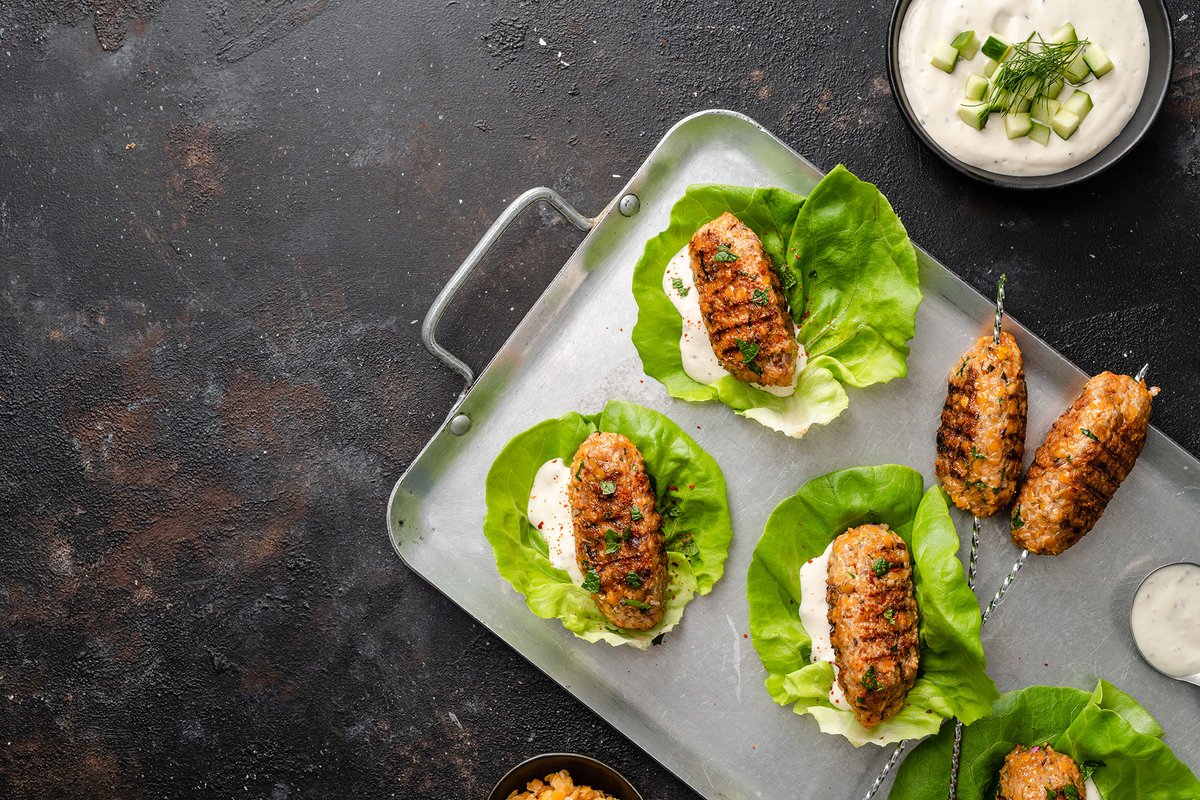 Turkish Lentil Kofte Lettuce Wraps: A blend of turkey, lentils, garlic, cumin, sumac, parsley, oregano, and mint formed into a kebab around a skewer and grilled, served in a crisp lettuce cup with a smear of tangy tzatziki. ow.ly/m6Xh50J6NUH