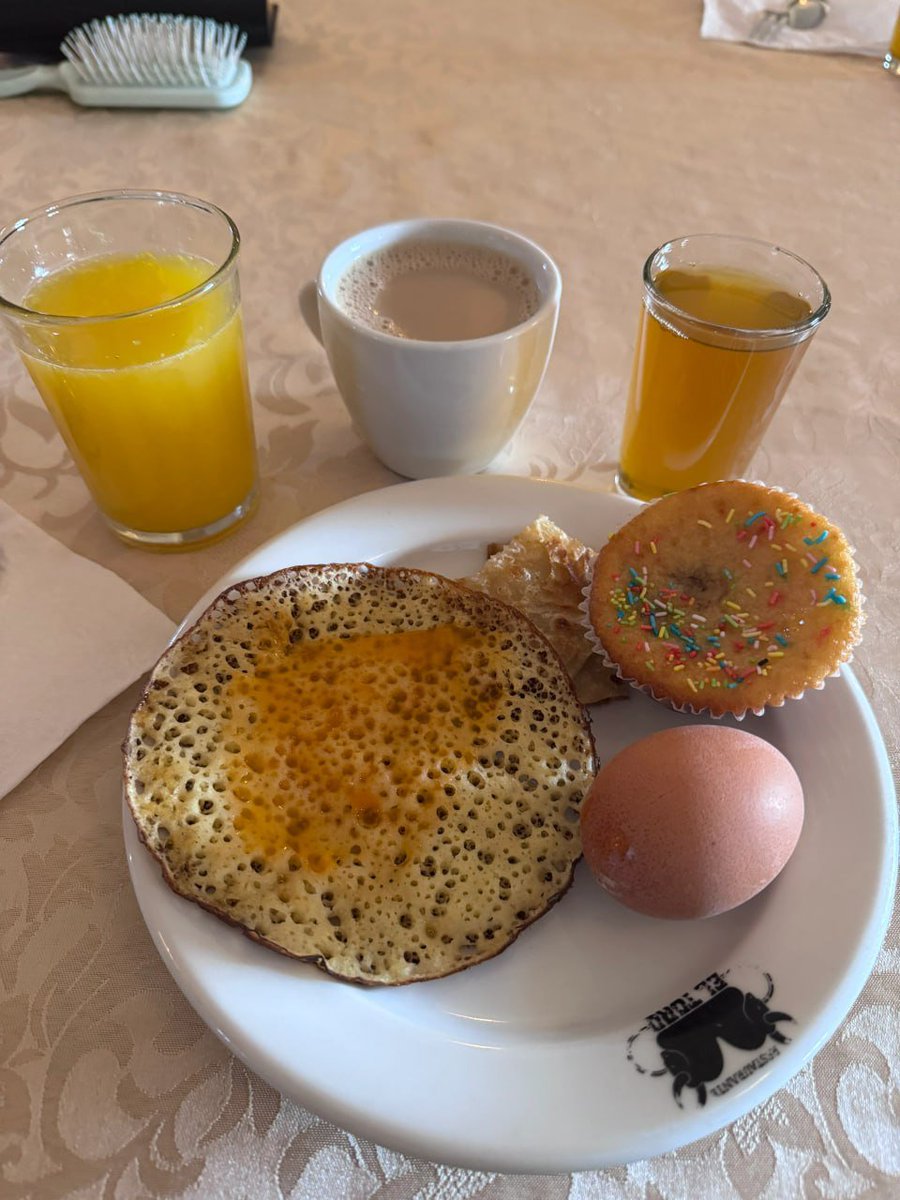 Starting the day with a delicious breakfast: pancakes, a boiled egg, a muffin, and fresh juice