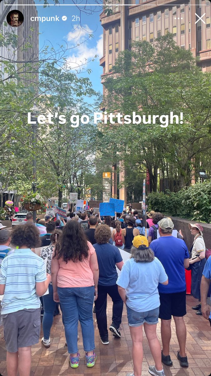 BackupHangman's tweet photo. CM Punk was in attendance for the UPMC Protest against their planned cuts to Gender Affirming Care scheduled to go into effect on June 30th.  

The protest took place today in downtown Pittsburgh. https://t.co/GefMVUUVaq