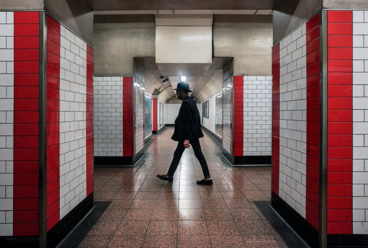 So this was a lucky photo that I didn't even know I had taken. 

I composed this symmetrical scene at St Paul's London Underground station, &amp; then suddenly loads of people rushed to catch the train. It was only when I was editing at home that I noticed I had captured a hat man!
