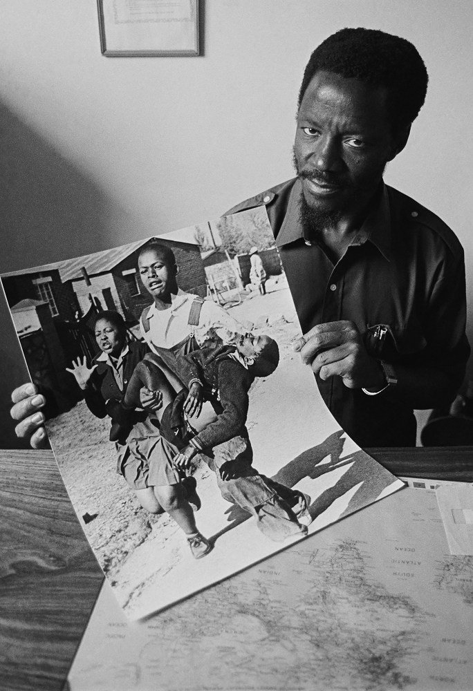 Sam Nzima with his iconic image of Hector Pieterson during the 1976 Soweto uprising.
