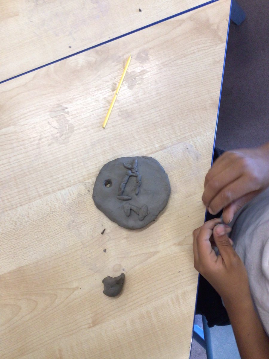 Year 2 are having lots of fun creating medals out of clay.