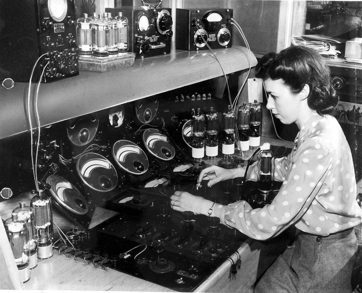 Quality control testing of high power vacuum tubes at the end of a tube production line at the Radio Valve Company (RVC) in Toronto, Canada 1944...The ones under test are type 813 tubes used in  RF amplifiers as well  in the AN/ART13 transmitter equipped on some B29 bombers.