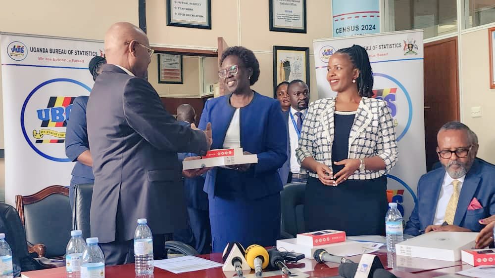 Dr. Mukiza,  the Executive Director of Uganda Bureau of Statists (UBOS) handing over 200 Tablets to Prof. Ezati ( center), the Vice Chancellor of  Uganda National Institute for Teacher Education (UNITE). Looking on ( right) is Dr. Allen Kabagyenyi, UBOS Board member.