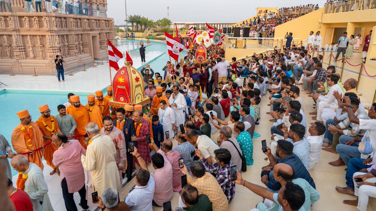 AbuDhabiMandir's tweet photo. Rath Yatra – the vibrant Festival of Chariots – was joyously celebrated at the BAPS Hindu Mandir, Abu Dhabi, uniting hearts in devotion and festivity.

The sacred images of Shri Jagannathji, Shri Balbhadraji, and Shri Subhadraji were beautifully decorated and placed in a specially adorned chariot for darshan from the day of Rath Yatra. For three days, the Mandir campus came alive with colour, music, and the spirit of devotion.

Yesterday, in the spirit of Puri, two divine chariots — one carrying Shri Jagannathji the other of Shri Akshar-Purushottam Maharaj, were led in a vibrant pradakshina around the Mandir.

Swamis, devotees, and members of the community joined together in pulling the chariots with joyous hearts, singing bhajans filling the air with spiritual fervour.