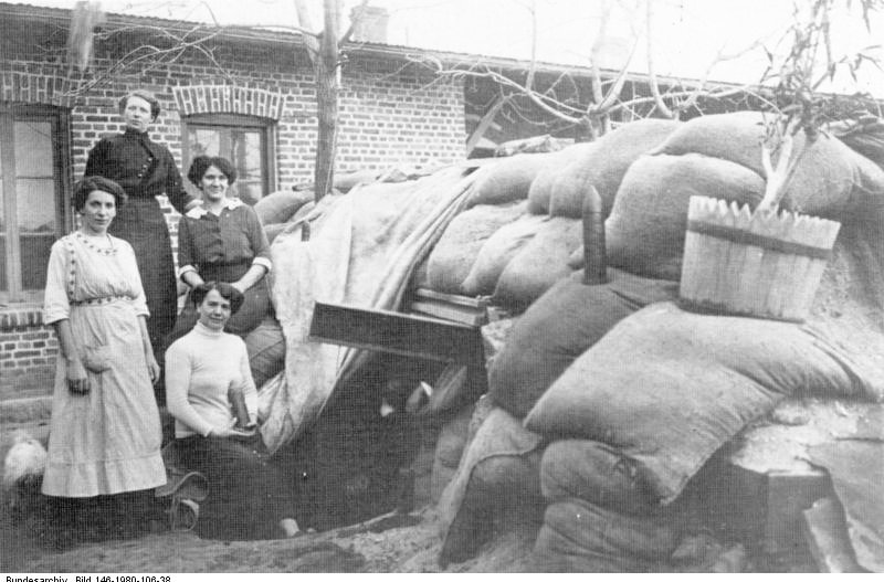 Nicolai Eberholst (Pike Grey 1914-1918) (@pikegrey1418) on Twitter photo Truly amazing photo of German civilians outside a bomb shelter in the streets of Tsingtao, China, during the Japanese siege of the German colony, November 1914. Note the unexploded shell standing on one of the sandbags. Truly amazing photo of German civilians outside a bomb shelter in the streets of Tsingtao, China, during the Japanese siege of the German colony, November 1914. Note the unexploded shell standing on one of the sandbags.