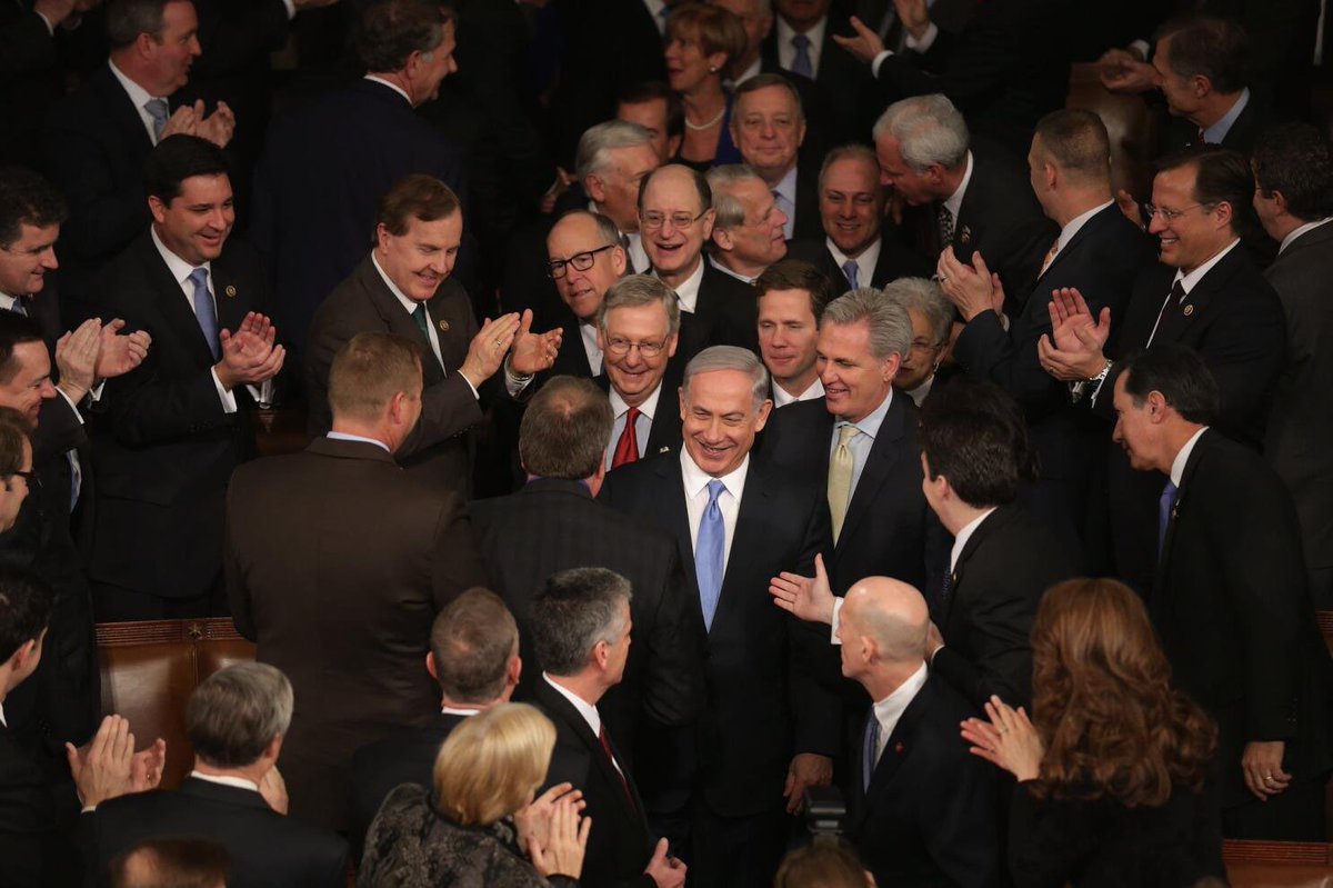 But a wanted, genocidal, war criminal is greeted by our representatives like a hero.