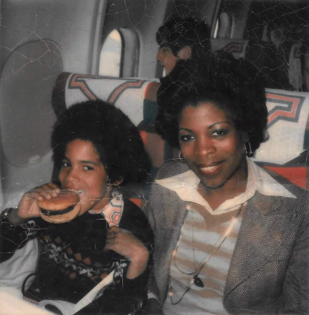 Actress Roxie Roker and her son Lenny Kravitz on the flight to Los Angeles for the taping of the first season of The Jeffersons (1975)