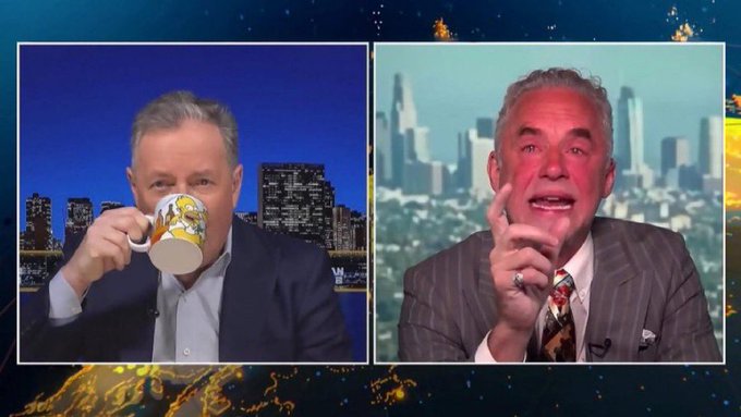 TV debate meme featuring two hosts with one holding a mug