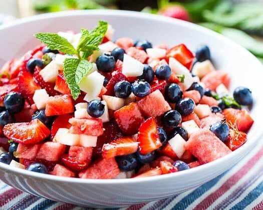Add a burst of cool to your #FourthofJuly spread with #salads that are are crisp, colorful, and made to beat the heat. This patriotic fruit salad from Spicy Southern Kitchen is a mix of watermelon, sweet strawberries, crisp jicama, and blueberries – all tossed with a minty