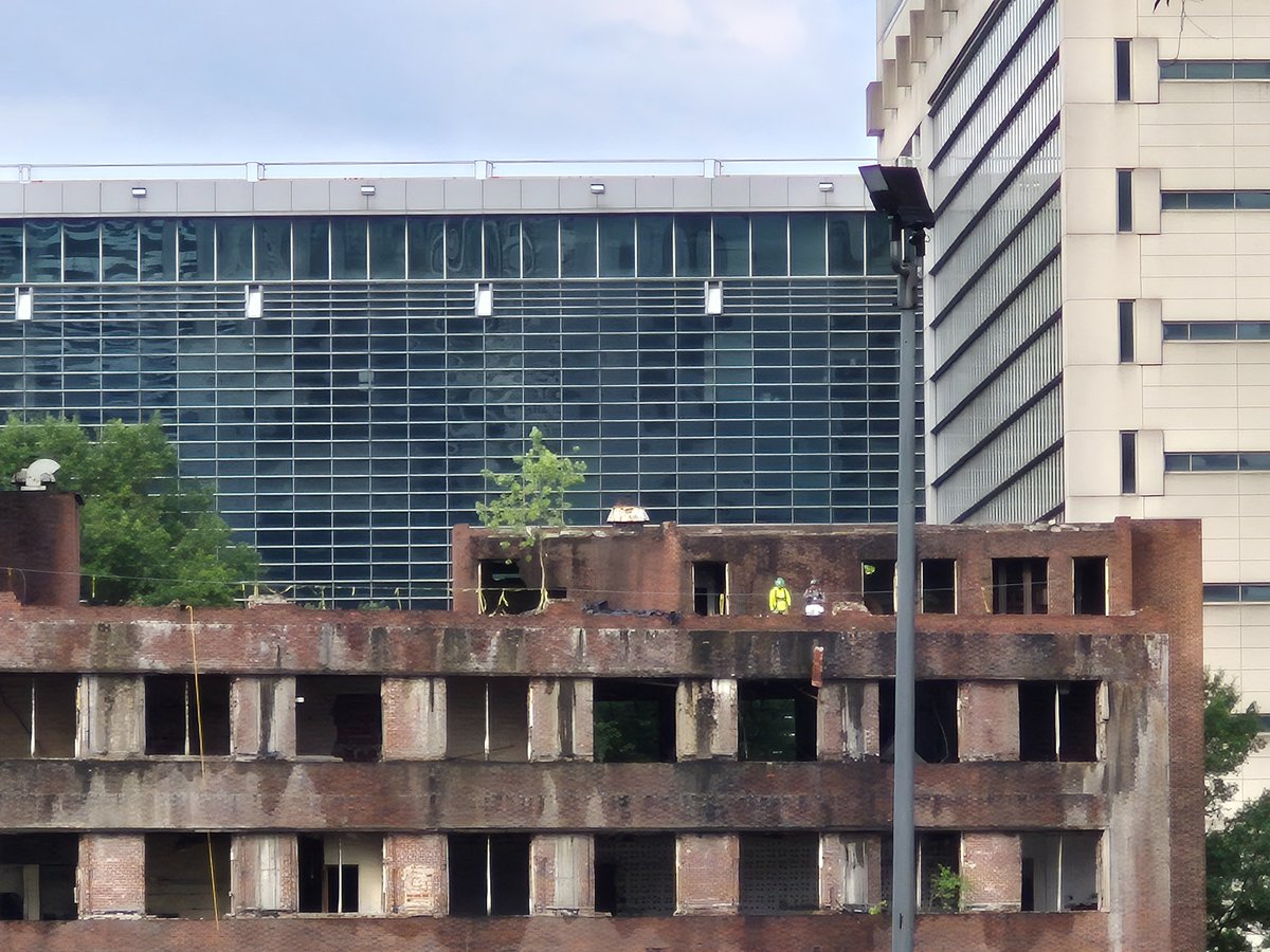 LathburyJason's tweet image. Seen: Workers on the roof of the Atlanta Constitution building