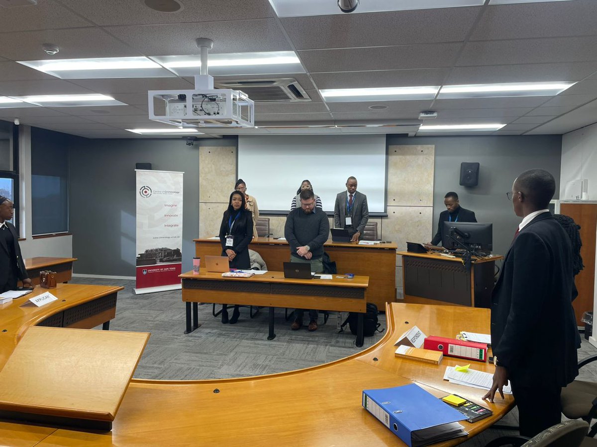 uculaw's tweet image. Preliminary Round 1: Team UCU Stacy Angel Ndawula and Aaron Alinda)takes a photo with the Judges, Team 16 and our almunus Lutaaya Allan Mark ( an LLM candidate at UCT) after the first preliminary round at The All Africa Human Rights Moot in Cape Town South Africa.