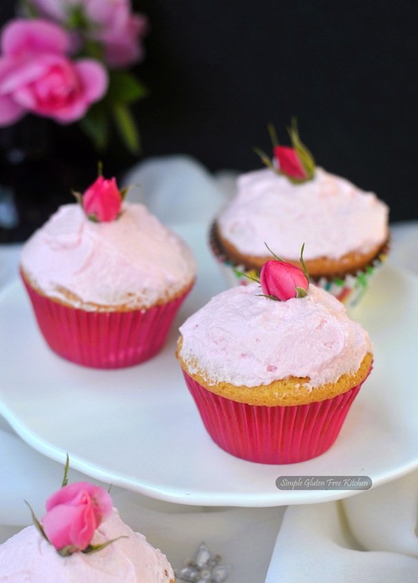 Summery rose-scented almond cupcakes. Soft, fragrant, gluten-free, and topped with rose buds from the garden. #CanadaDay 
simpleglutenfreekitchen.com/2025/06/rose-s…