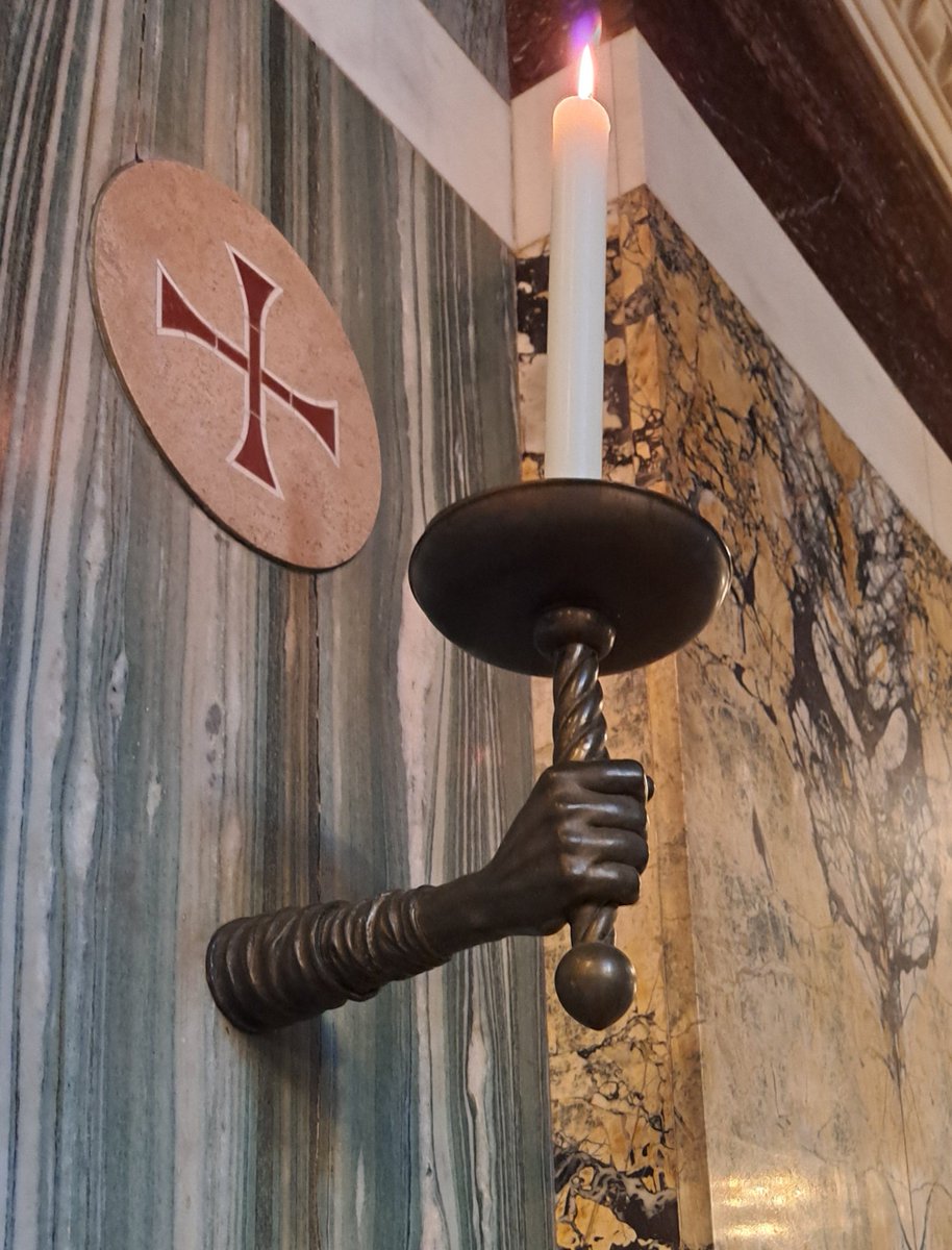Well held: one of the candles at consecration crosses today for the solemnity of the Dedication of Westminster Cathedral.