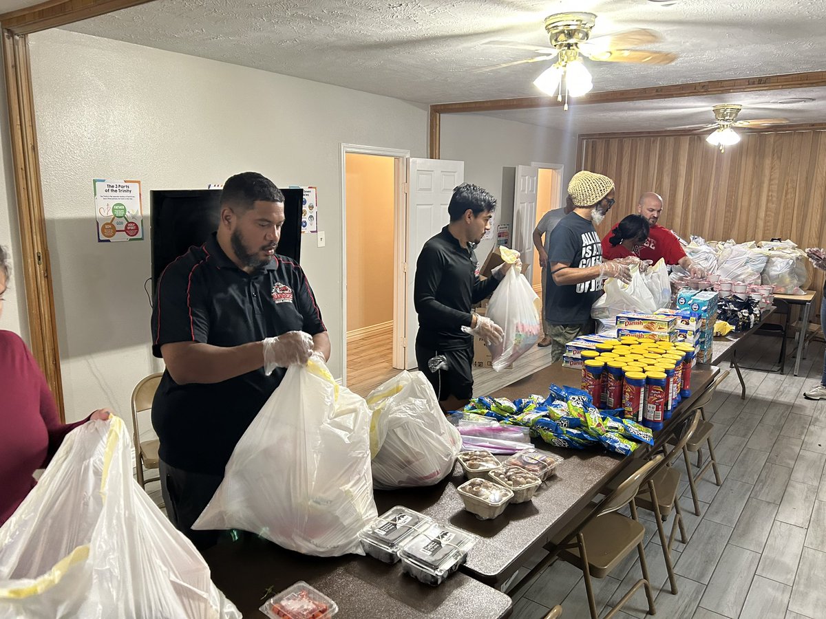 Terry and George Coaches doing community service and giving back to the community by packing food for families in need!