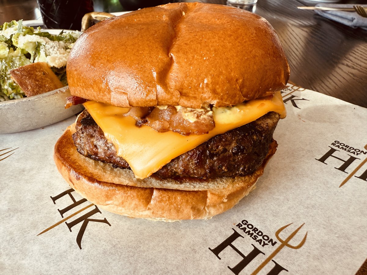 With a very nice smoky flavor and topped with applewood smoked bacon, the Backyard Burger at Gordon Ramsey''s Hell's Kitchen DC's Wharf. 
Good to very good. Only drawback -would have liked a little more beef.