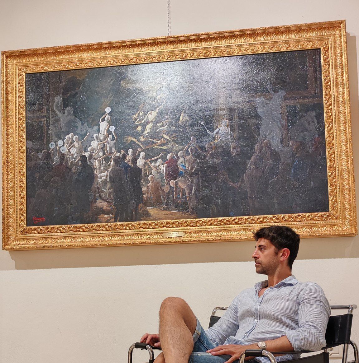 The artist and his new artwork in the gallery