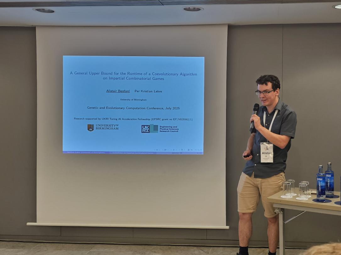 Alistair Benford presenting our runtime analysis of co-evolutionary algorithms on combinatorial games at <a href="/GeccoConf/">GECCO 2026</a> He shows that the runtime can be upper bounded in terms of a graph invariant called switchqbility.