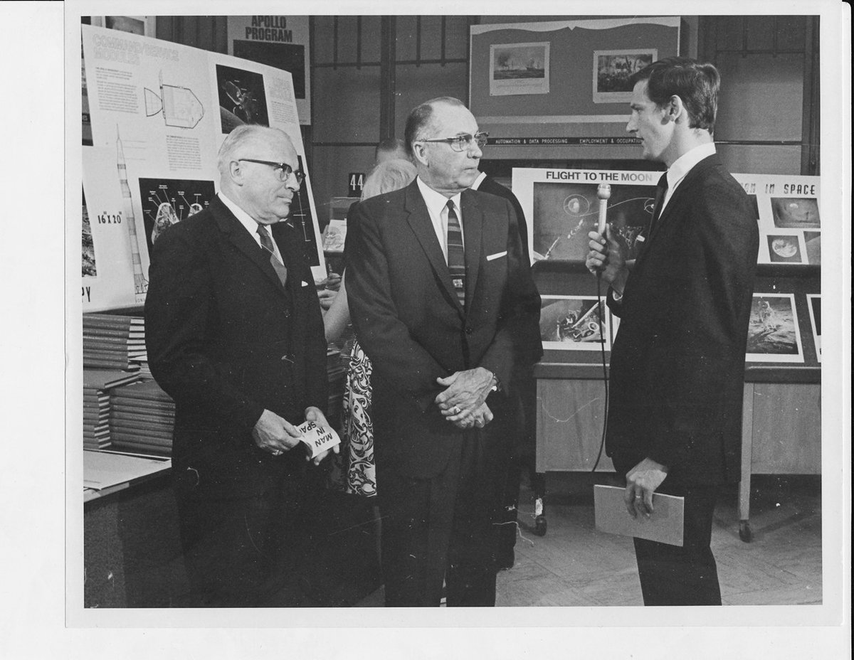 USGPO's tweet image. Today is the anniversary of the moon landing. In the days surrounding the 1969 landing of the man on the moon, the demand for @NASA & space-related publications surged. Here, a local DC news reporter interviews Public Printer Harrison in front of the Apollo 11 display at the…