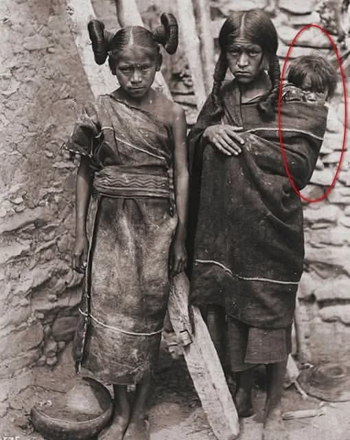 This photograph, taken around 1898 by Wharton in Arizona, captures a Hopi mother and daughter