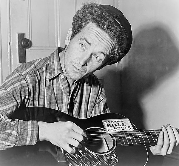strombo's tweet image. “Every living song I’ve ever made up is a hard times song of protest" Woody Guthrie born on this day in 1912