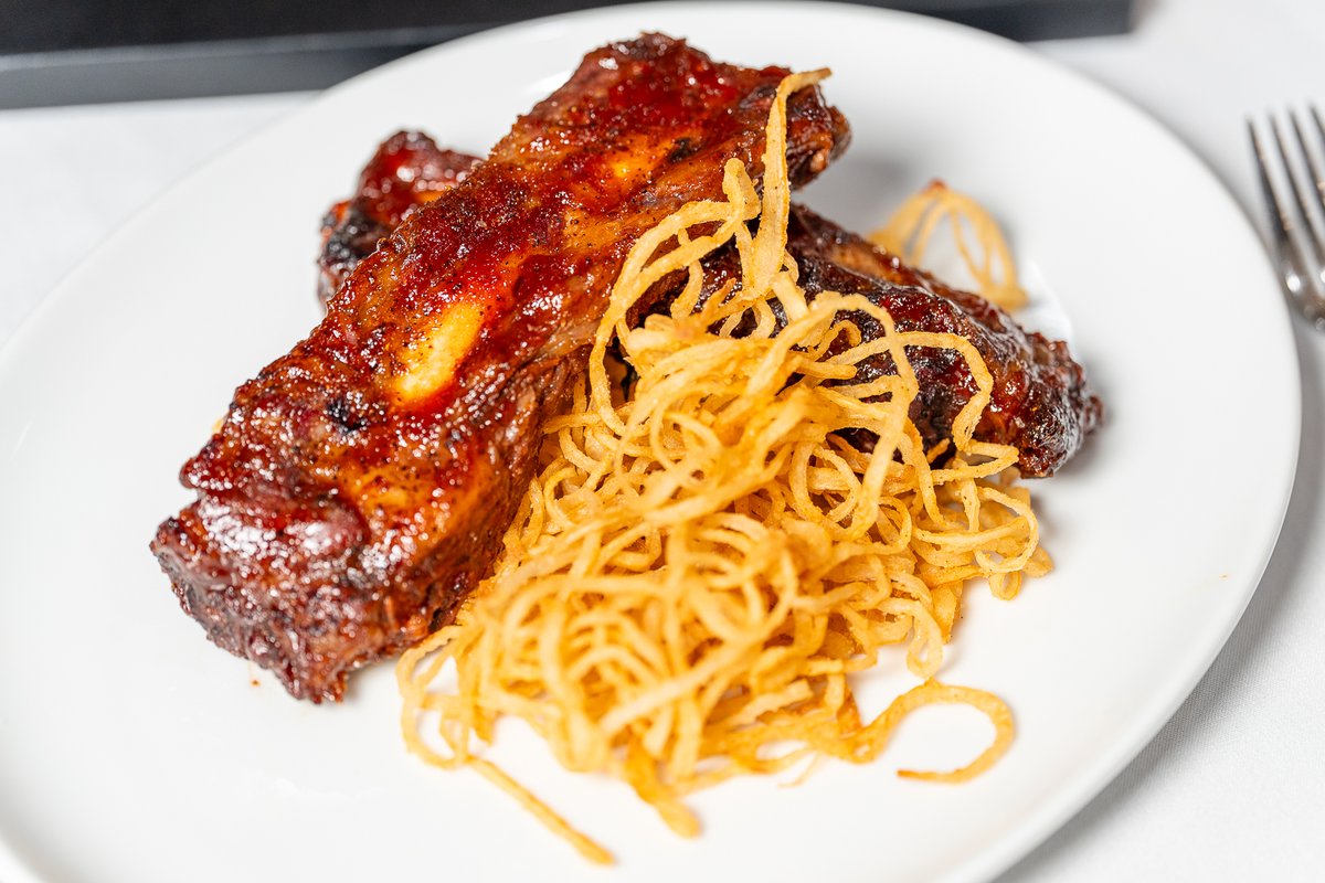 The mouthwatering BBQ roasted beef ribs with fried onions are the stars of Social Hour this month at The Angry Butcher Steakhouse! 🍖 Don't miss it!
