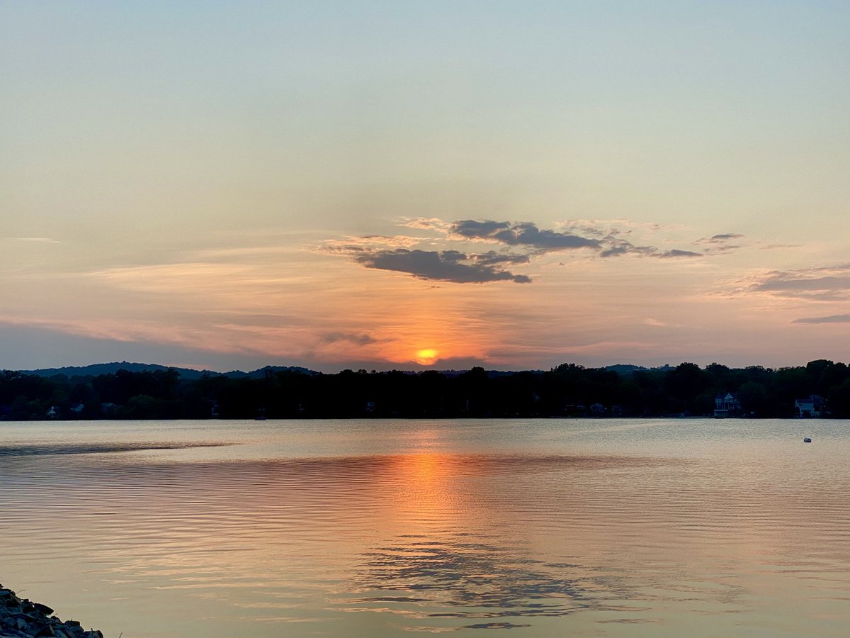 I got a beautiful shot😁! the sun just kissing the horizon, and the reflection across the water is perfectly smooth and warm. The colors are subtle but rich — that soft gradient from orange to lavender is really calming.