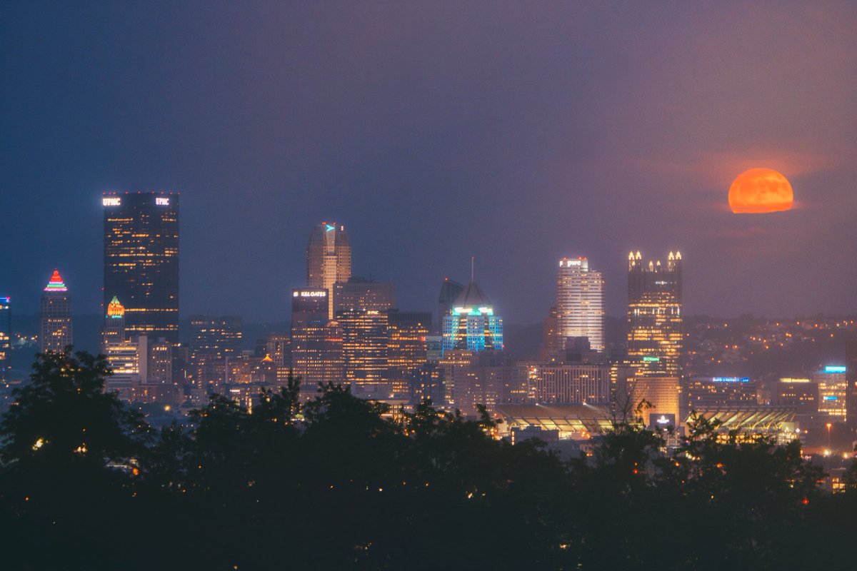 DaveDiCello's tweet image. Another full moon image from #Pittsburgh last week, this time a wider view featuring the entire skyline from McKees Rocks. I didn't notice the orange glare from the streetlight until I downloaded the images, but it gives the image a cool, retro vibe.