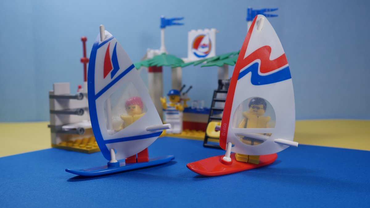 A little summer fun with 6595: Surf Shack from 1993, with three different sails for windsurfing, a bar with palm frond awnings and a man with very short shorts.