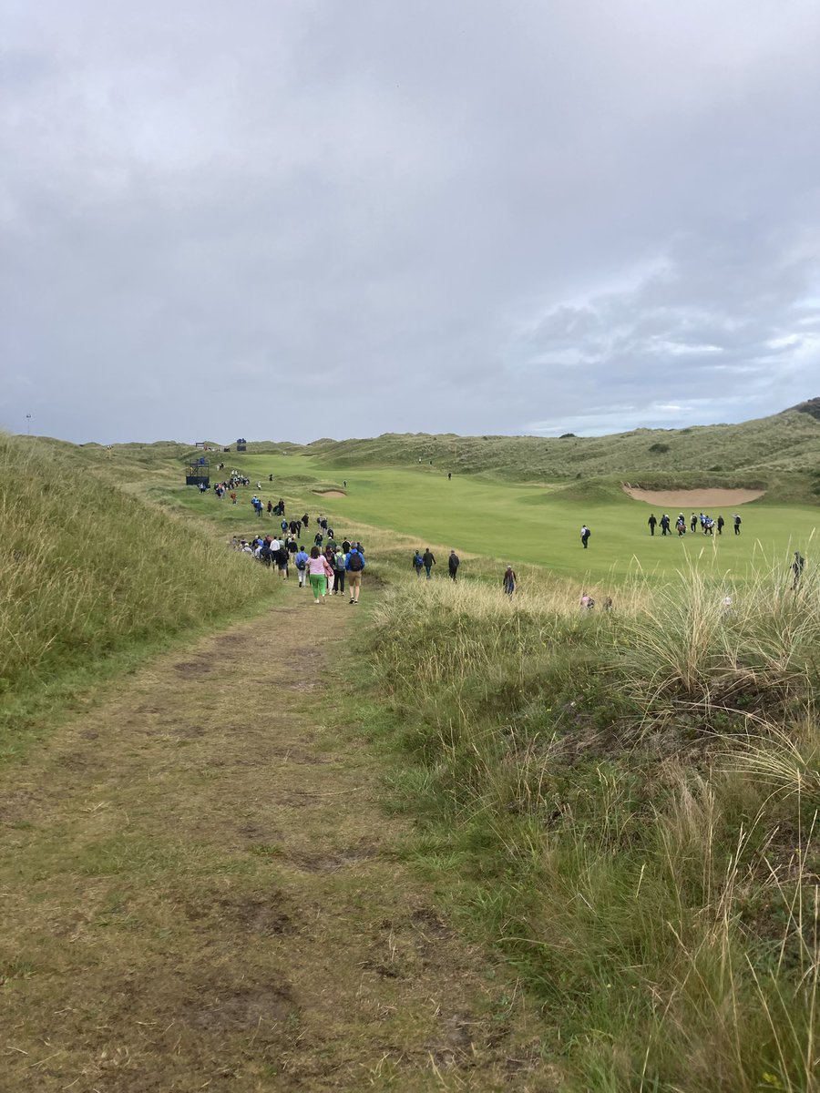 Still just a spattering of fans following McIlroy, McKibbin and Clarke as they go up the par 5 seventh