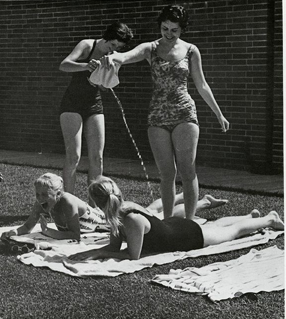 #DYK that spring and summer terms are times for high-jinks and suntans around an outdoor pool? This photograph taken in 1961 shows two women pouring water on their sunbathing friends. Happy Summer! #MSUHistory