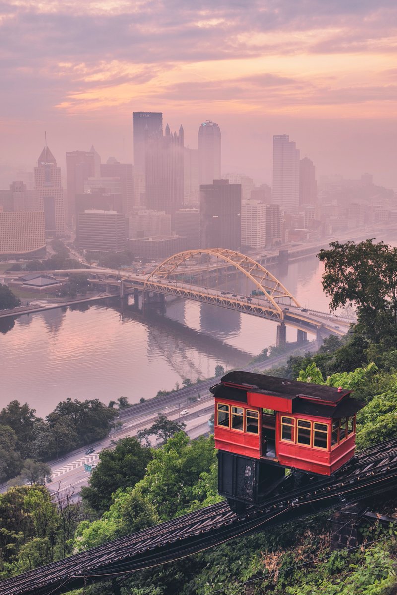 DaveDiCello's tweet image. A foggy view from the Duquesne Incline in #Pittsburgh a few weeks ago. The sun gave the haze and fog around the city this pinkish glow which made it look like something out of a movie behind the incline.