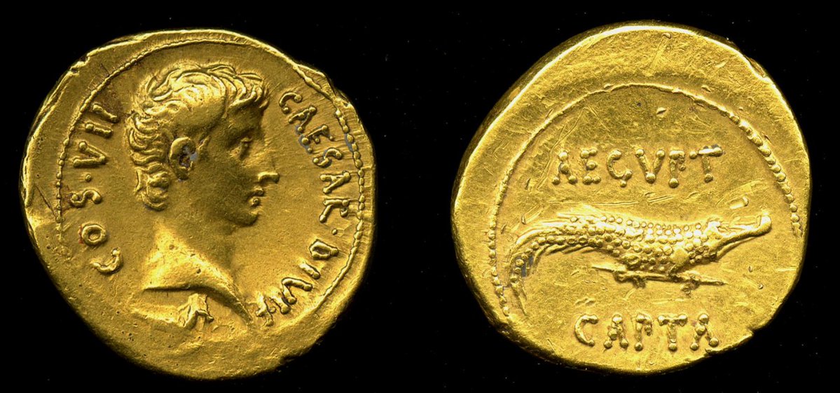 DrJEBall's tweet image. A #Roman gold aureus with a side-portrait of the emperor Augustus on one side, & a crocodile on the other, with the words AEGVPT CAPTA ('Egypt captured'. It celebrated Egypt becoming a Roman province following the defeat of Antony & Cleopatra in 31/30 BC - a beautiful coin! 🐊