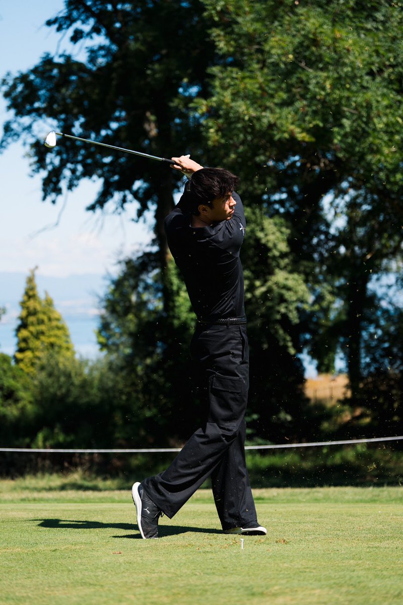 Is Alex using an iron to hit the ball off the tee?