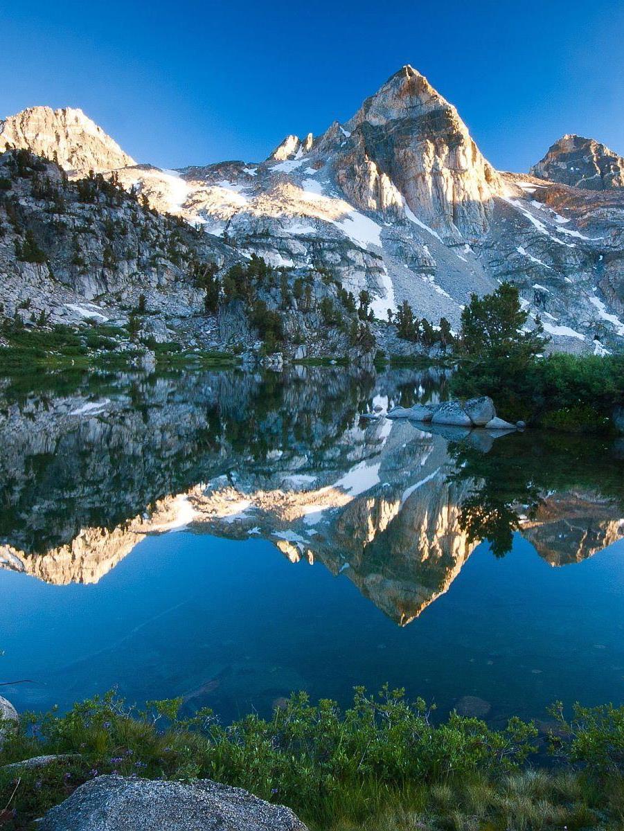 Beautiful blue morning sky forms almost perfect mirror on Bear Lake in the Rocky Mountain National Park, Colorado, US  🇺🇸