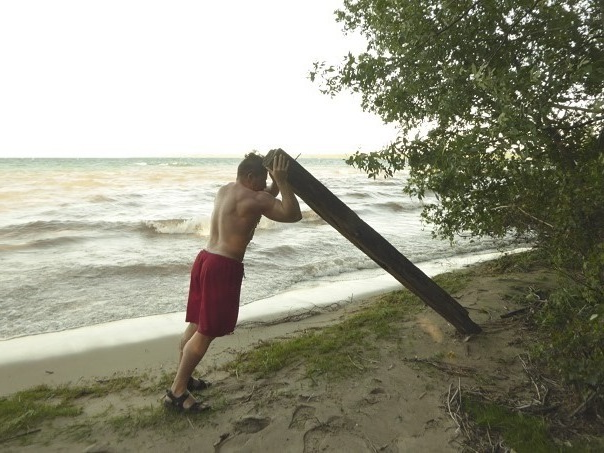 At the beach, using driftwood log, go for a 3 set 39 rep per side joystick claymore landmine twisted shoulder press with lumberjack front squats then add progressive resistance overload for desired effect. #1Peter3:14 #stayingalivein2025 #fattofitnoquit #fightyoflight #fababs