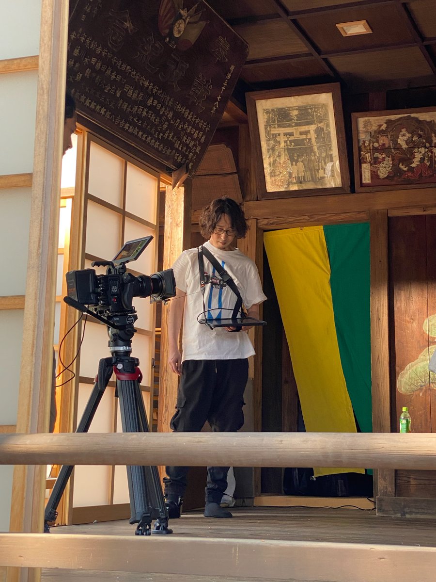Nyardaughter's tweet image. 【#ナイアル娘 撮影レポート‼️】
本日は撮影二日目、とある神社での撮影風景をお届け!
監督の首筋から見えているのはハンディ冷却装置。
6月上旬とはいえ快晴☀️の暑い日だったので、過酷な撮影に臨む準備は万全です😤