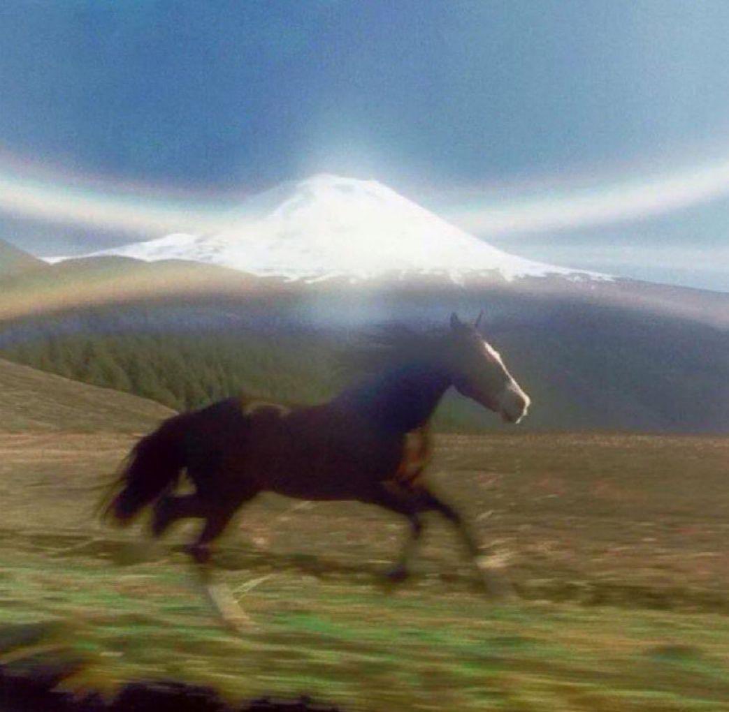 horse running past glowing mountain rush and freedom motion blur