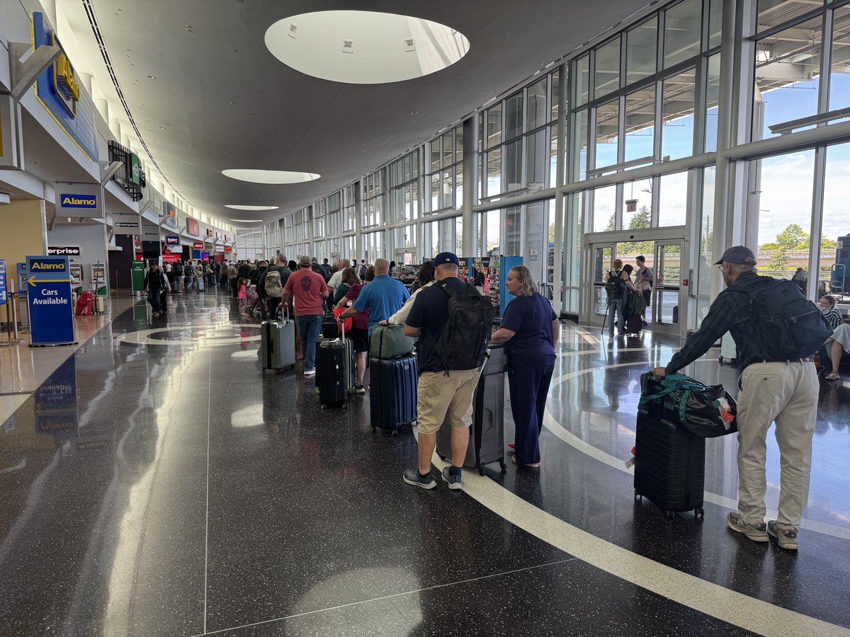 Etulain's tweet photo. @Budget line at SeaTac right now. More than 100 people in line, with only 2 people working the counter. https://t.co/3cjZUf24E7