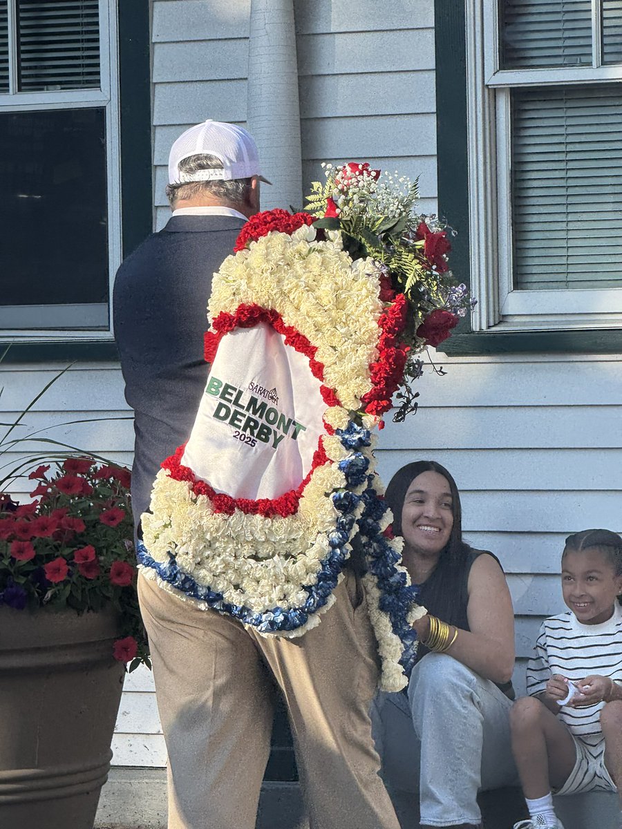 Team Amerman, winner of the Belmont Derby Invitational, with Test Score leaving with the garland and saddle towel (and sharing a flower with a fan).