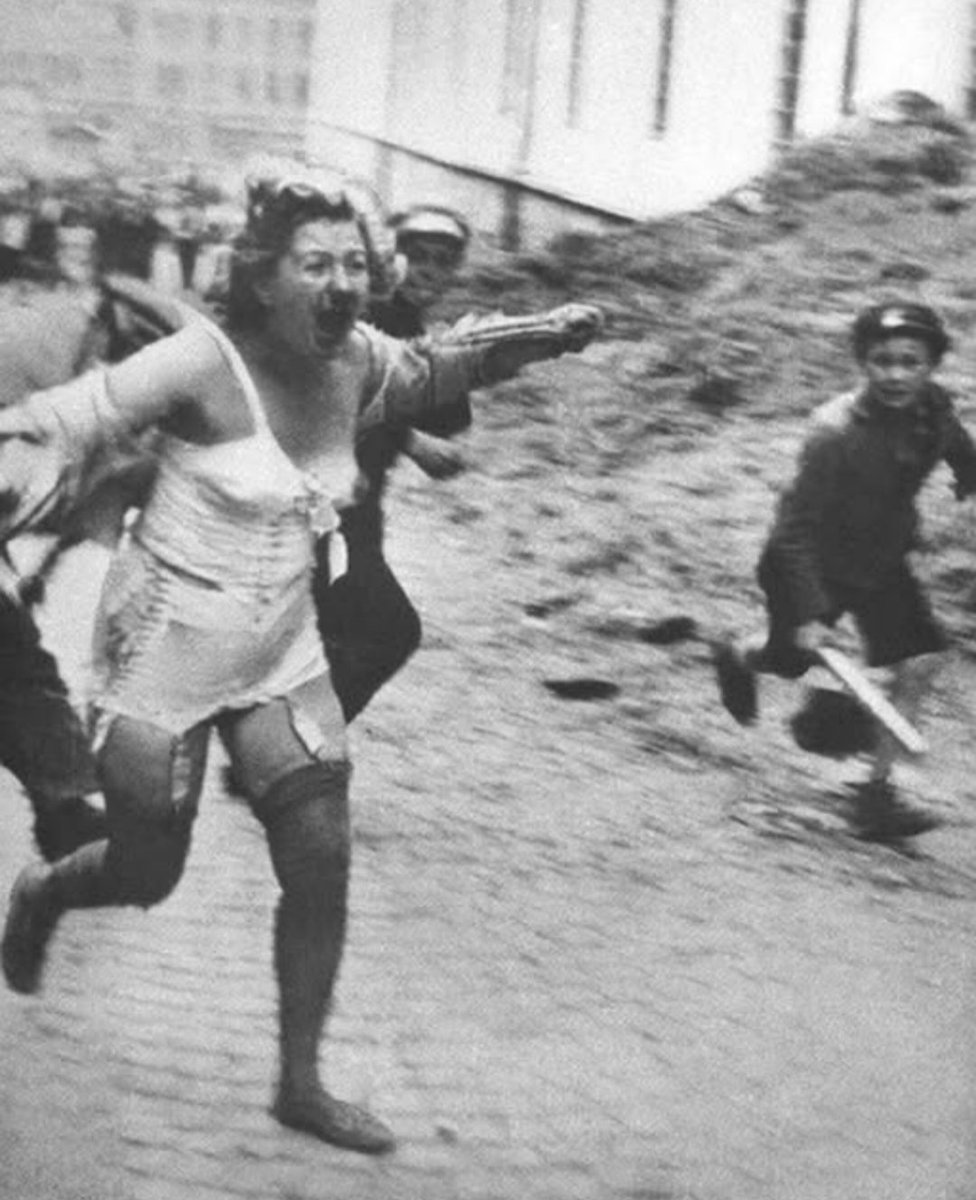 AfgZoroastrian's tweet image. She was not a traitor. She was not a spy. But on August 18, 1944, she was dragged through the streets, her head shaved, holding her child — punished because of love.
This powerful photo was taken by famous war photographer Robert Capa in Chartres, France, during the freeing of…